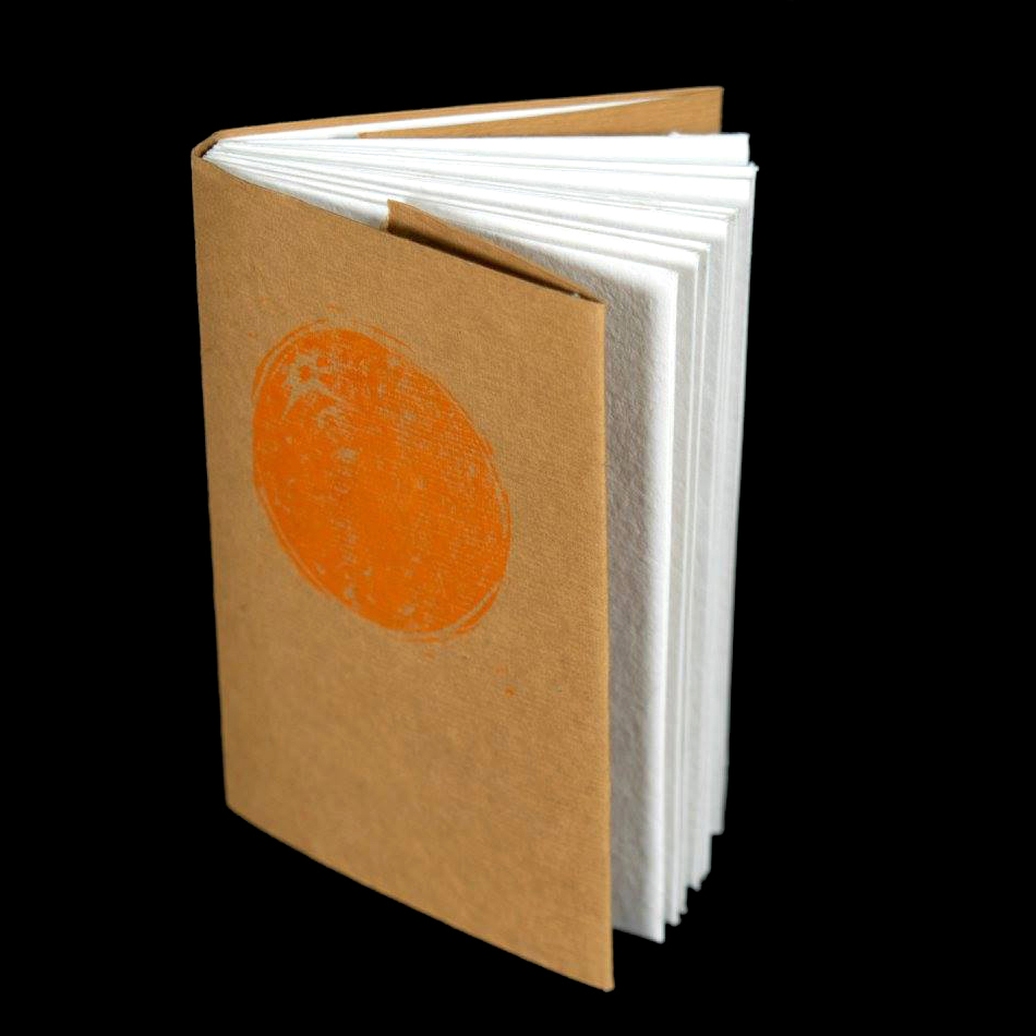 small book with brown paper cover that has an image of an orange on it. Link to The Orange.